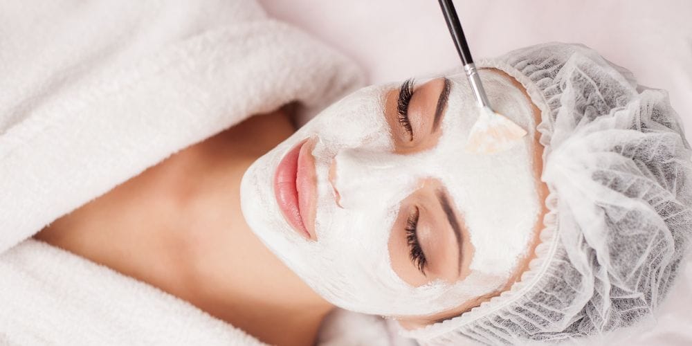 Woman receiving a facial at a local day spa.